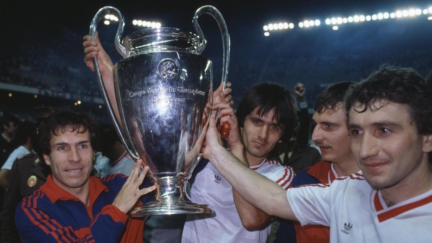 Steaua Bucharest players, including goalkeeper Helmuth Duckadam, lifting the 1986 European Cup trophy in celebration on the pitch